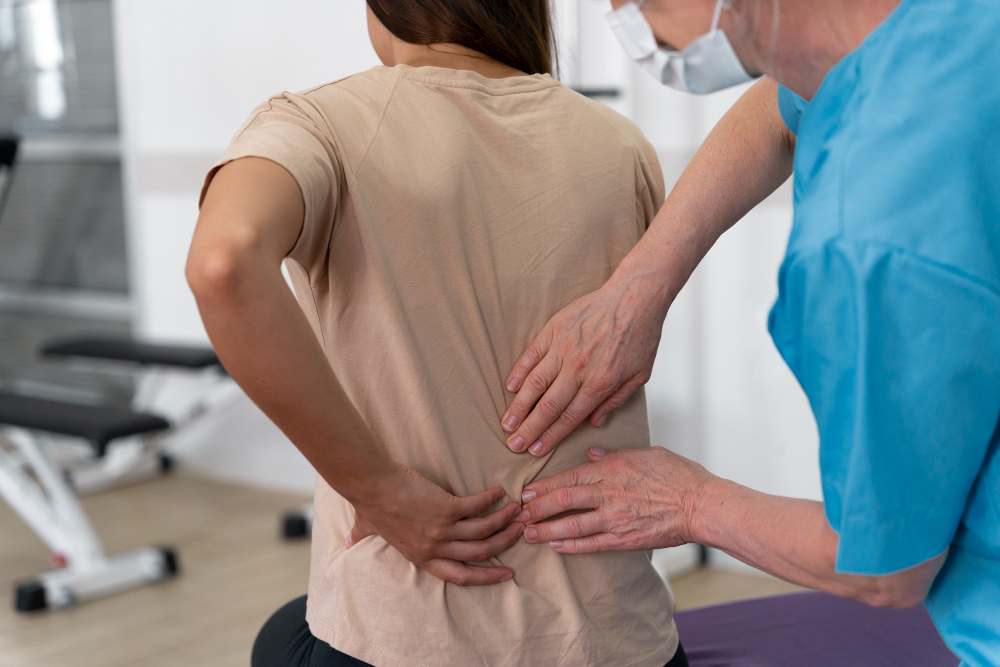 Elderly patient receiving physiotherapy at home for back pain